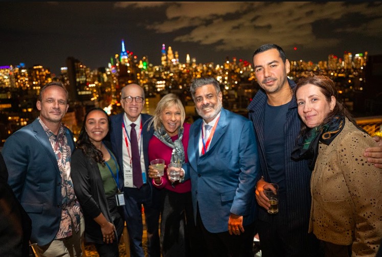 Guests at an evening reception overlooking the New York City skyline